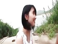 This adorable Asian babe plays outside.